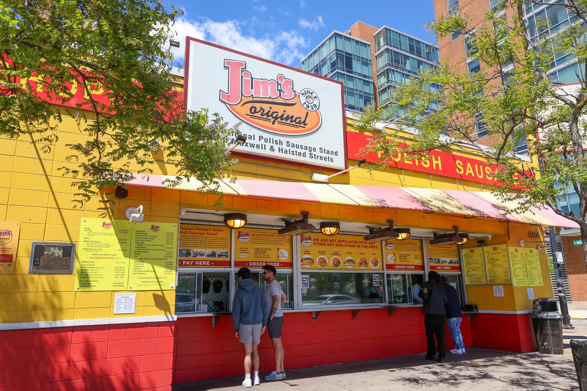 Yellow and red Jim’s Original walk-up stand in Chicago with exterior signage.